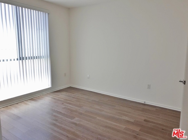 Bedroom with wood floors - 1611 S Beverly Glen Blvd