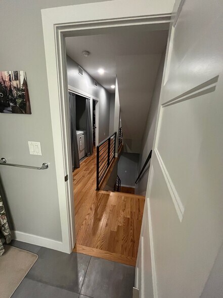 bedroom level hallway with washer and dryer - 3326 S Washington St