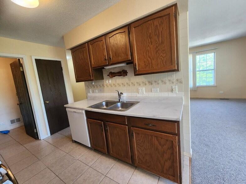 Kitchen sink with laundry room and furnace room on the left - 326 Plumwood Ln