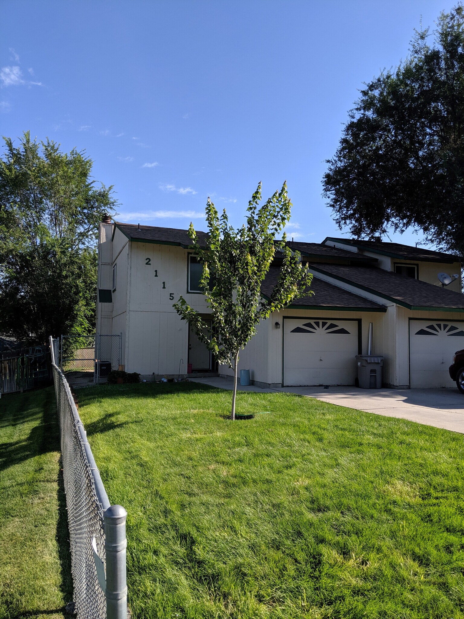 A view of the property from the street. Neighbor's property in the background. - 2115 Pleasanton St