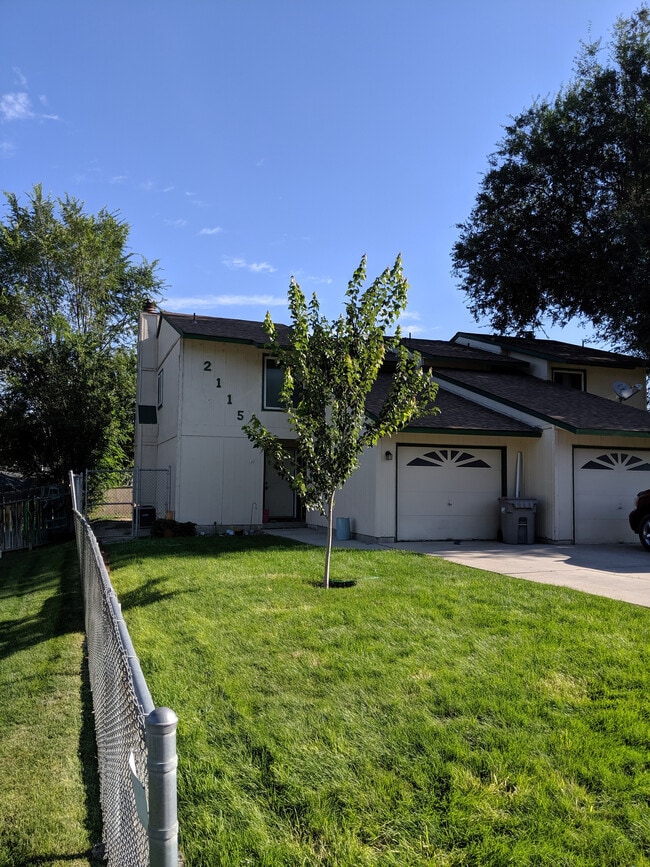 A view of the property from the street. Neighbor's property in the background. - 2115 Pleasanton St