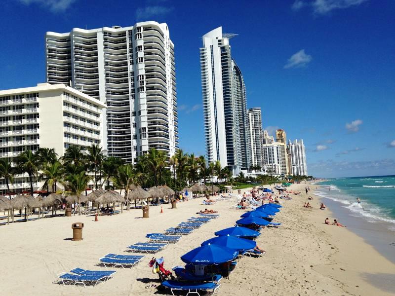 Beach with chairs, umbrellas & towels - 16699 Collins Ave