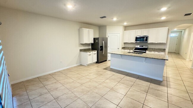 Building Photo - Available NOW! Spacious 4BD/2BA Haven in Villages at Harmony – Your Dream Home Awaits! WASHER & D...