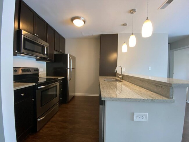 Upgraded kitchen with rich wood cabinetry - 1818 North Halsted