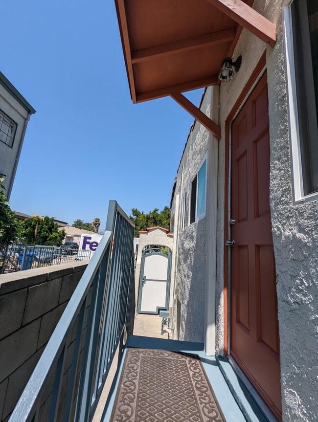 Side door opens to semi-private path to white gate and private laundry room - 1830 S Curson Ave