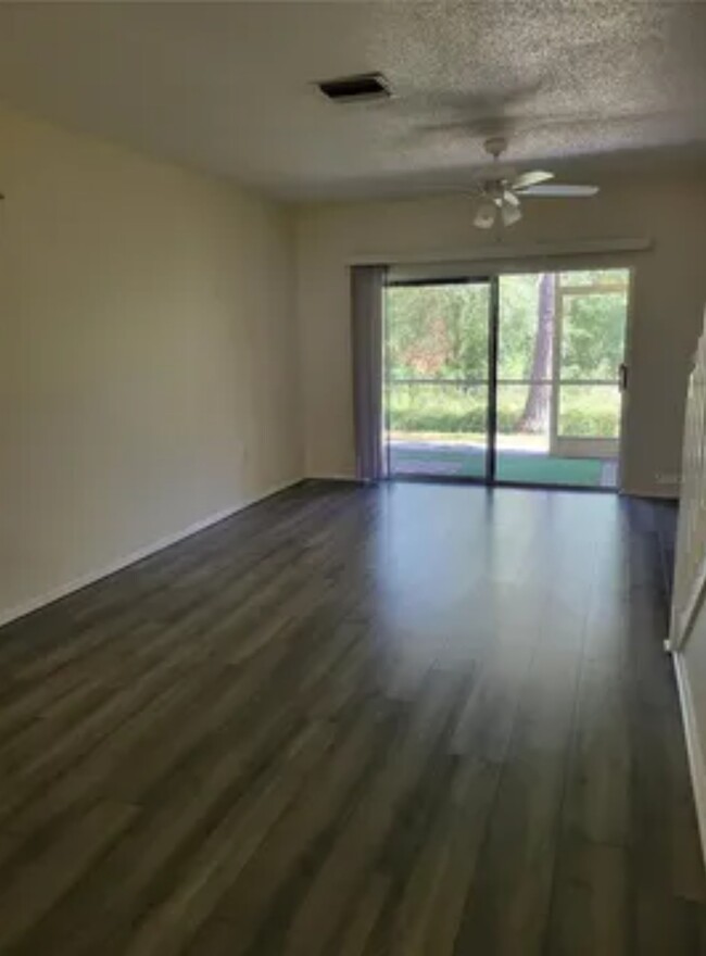 Open living room and dining room - 8661 Hunters Key Cir