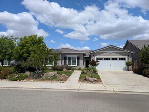 Building Photo - Modern 5 bedroom 3 bathroom home in the Riverstone Community offering solar, In-laws suite, den o...