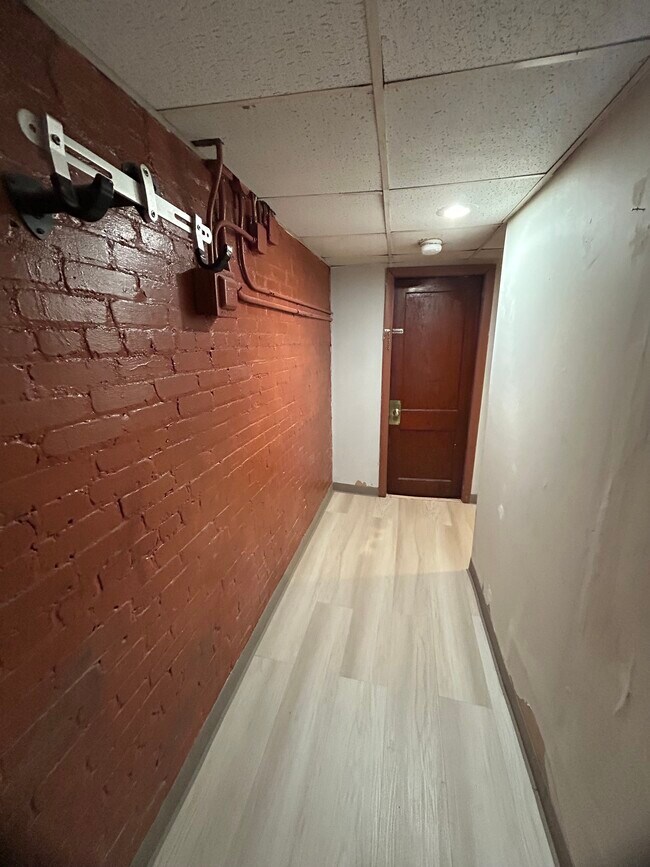 Entry into the apartment with adjustable wall-mounted bike rack - 397 Boylston St