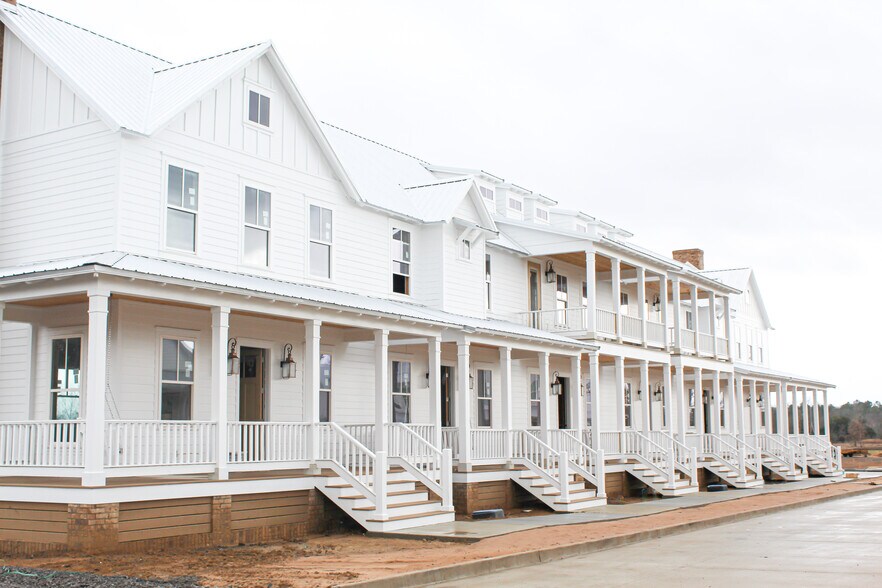 Townhome is on the far right end with the larger porch and faux chimney! - 2100 Loretta Parker Ln