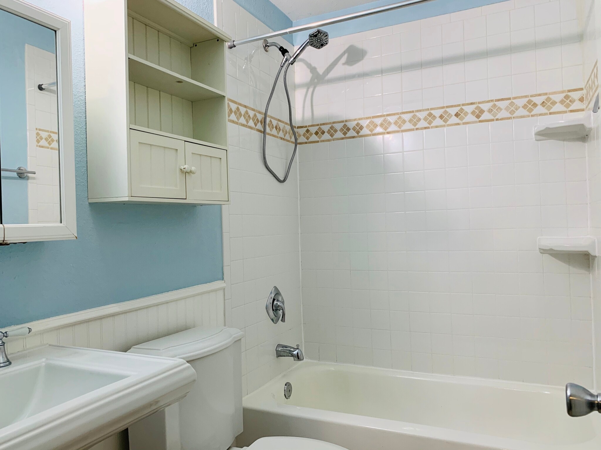 Bathroom with tub and removable shower head. Plenty of additional storage. 407 E 45th St, Austin, TX 78751 - 407 E 45th St #116