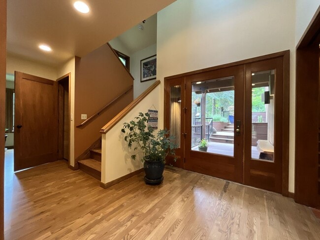 Building Photo - One-of-a-Kind Custom Home with Wall of Windows, Stone Fireplaces, Expansive Entertainment Space &...
