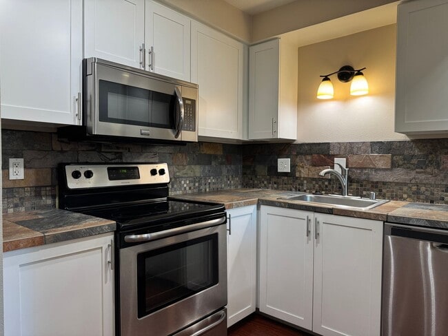 Building Photo - Serene Ground-Floor Condo Overlooking Green Space – Parking Included