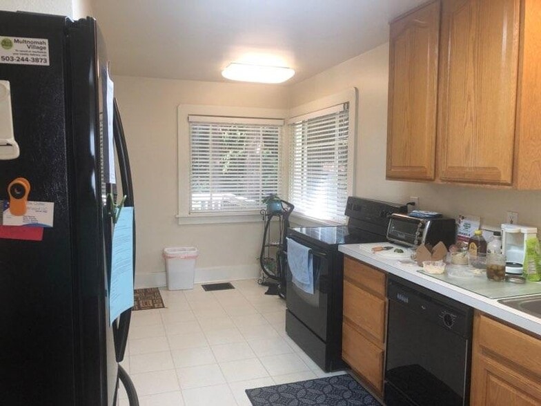 Kitchen showing fridge, stove & DW - 8528 SW 35th Ave