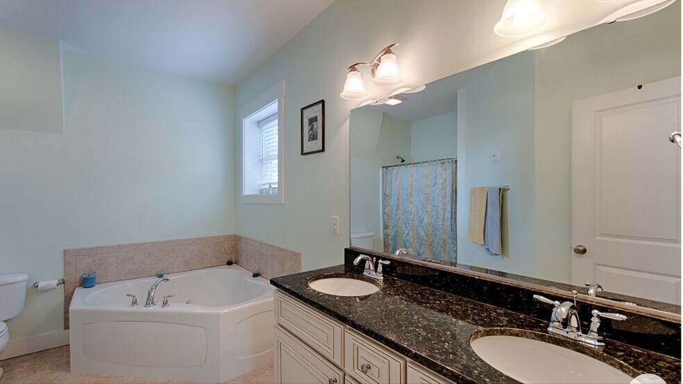 Primary bath with double granite vanity, jacuzzi tub, and separate shower - 144 Estelle Park Dr