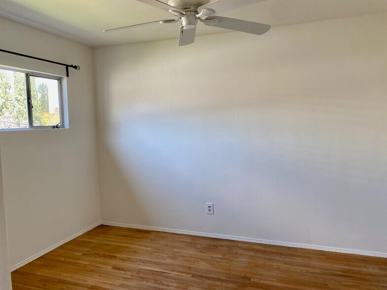 Bedroom with a ceiling fan and an A/C unit - 4039 Duquesne Ave