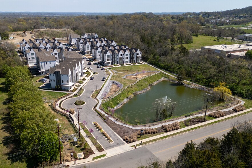 Enjoy access to walking trails, green space, and a scenic pond with fountain just steps away! - 358 E Village Ln