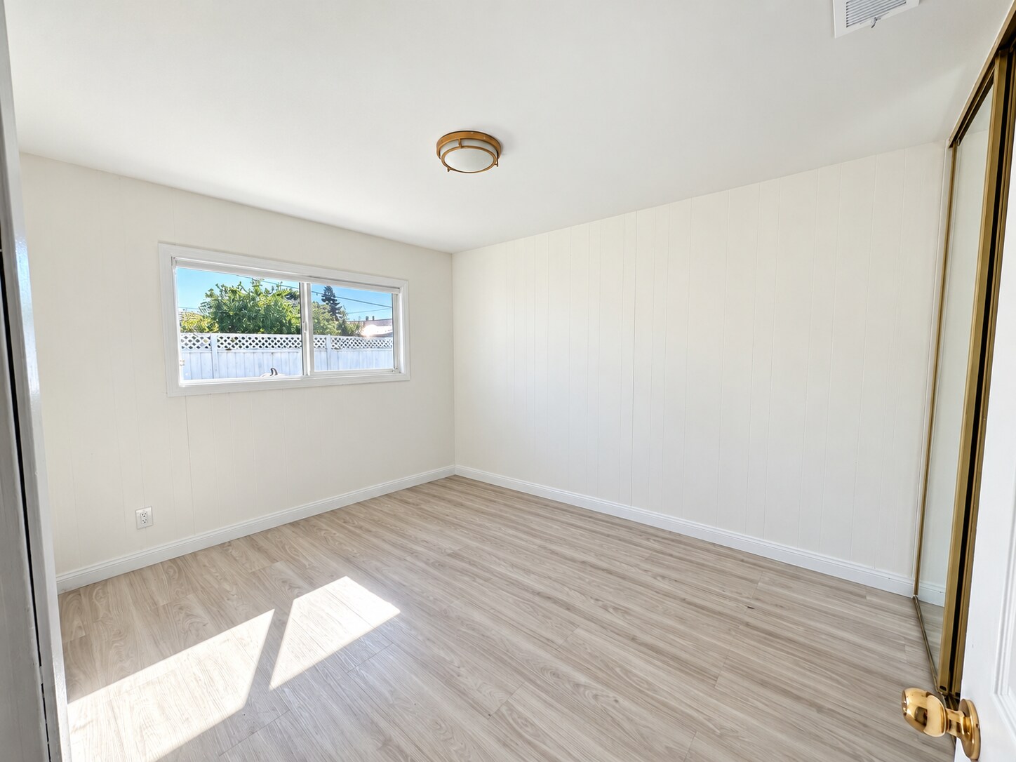 Bright secondary bedroom with updated flooring. - 826 San Pablo Ave