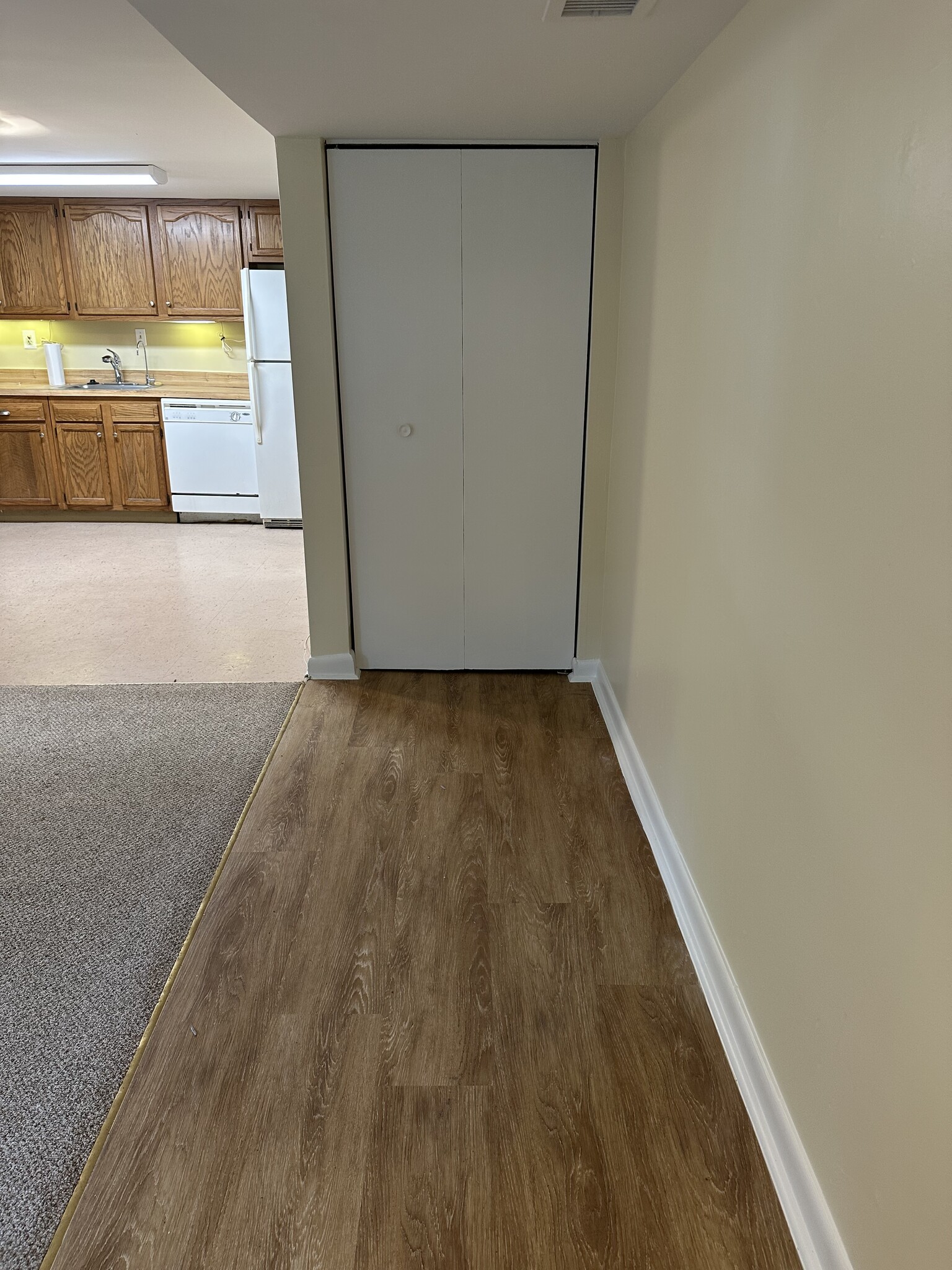 Laminated flooring in entrance with entry closet - 1336 Kenyon St NW