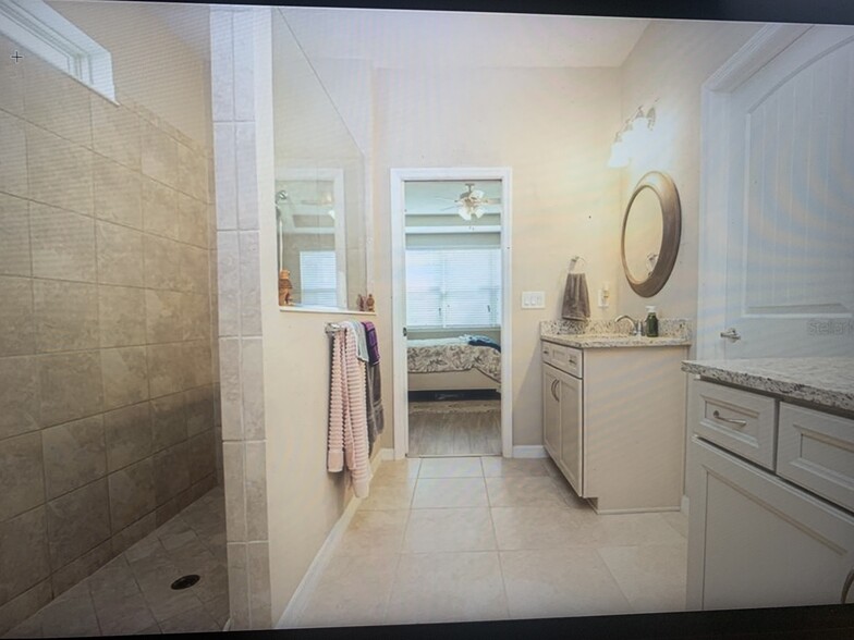 Master bathroom with 2 separate vanities. Rainfall shower and large shower. Toilet is separate - 8012 Olive Brook Dr