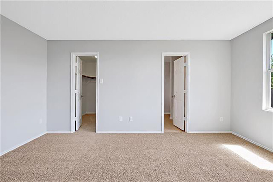 Master closet (left) and master bathroom (right). Woodgrain tile in master not pictured. - 1419 Windy Meadows Dr