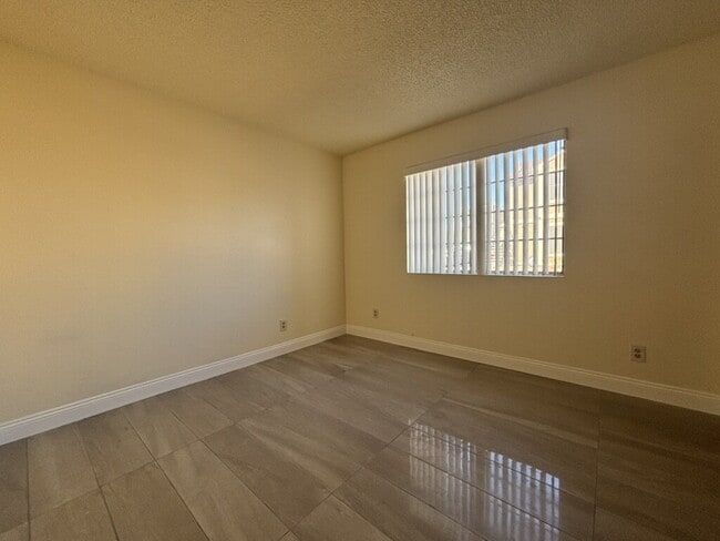 Building Photo - Downstairs 2BR/1BA—recently updated with new flooring, new countertops, and clean, neutral finishes.