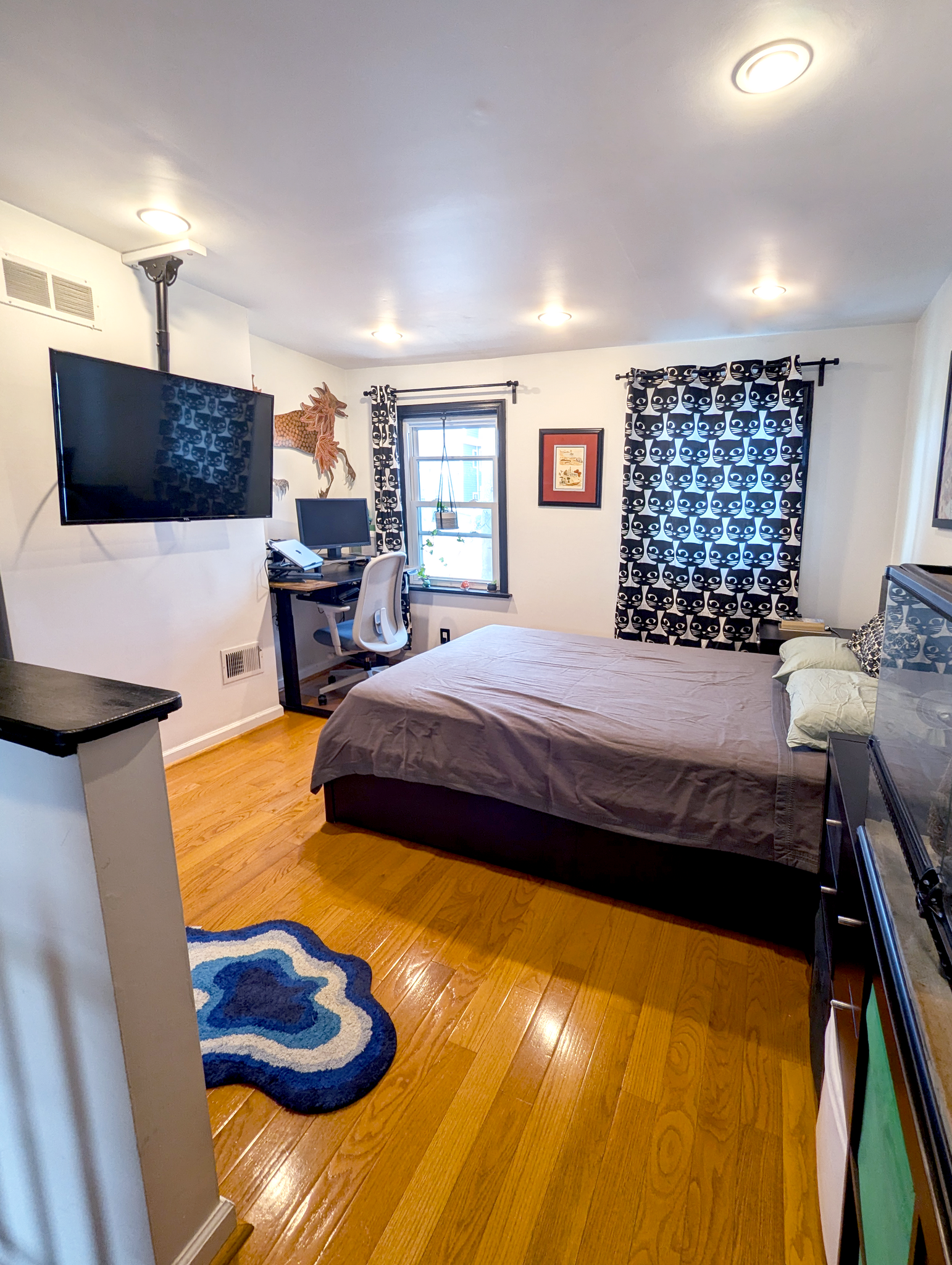 3rd floor master bedroom has space to relax, work, and recharge. TV mount included if desired. - 1138 Day St