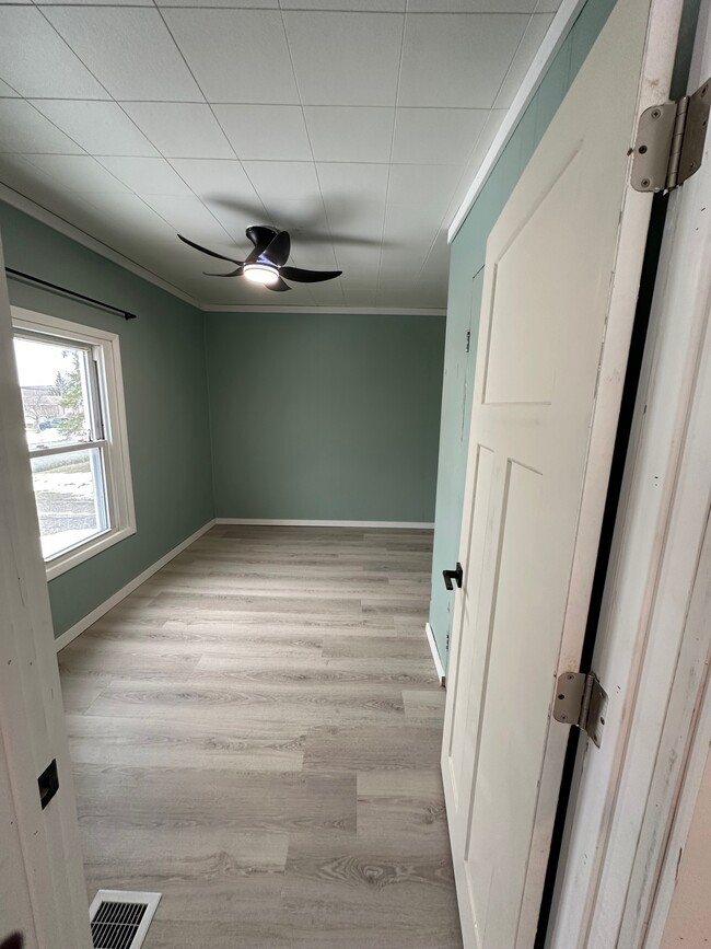 Bedroom off of living room with closet. - 8215 Lake Pleasant Rd