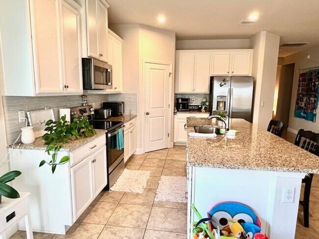 Building Photo - Open concept home offering four bedrooms, three baths, a two car garage and open lanai.