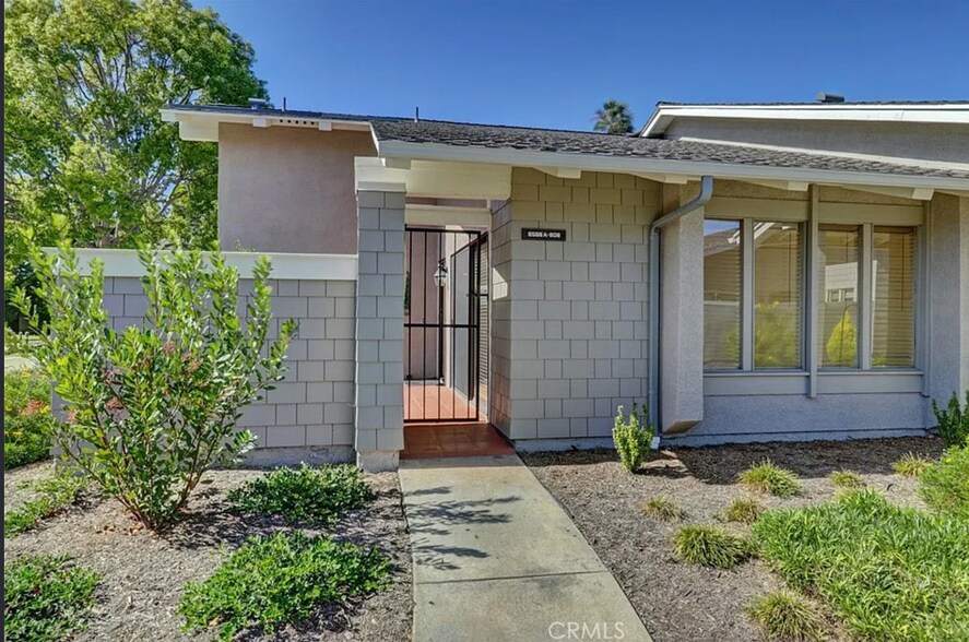 Courtyard entry and living room with view of greenbelt. - 8566 Larkhall Cir
