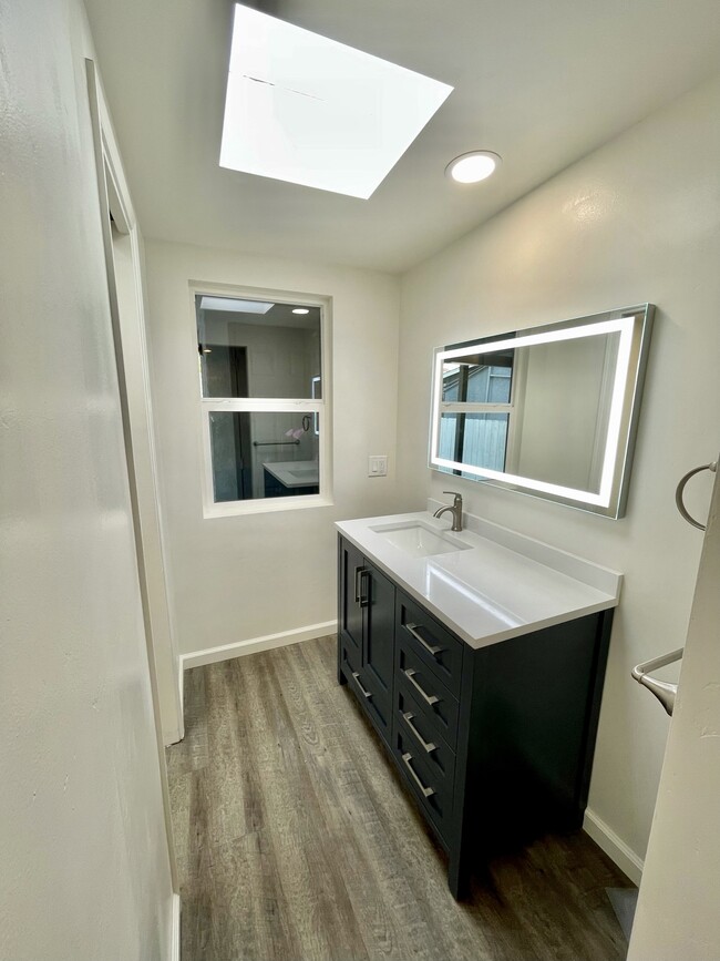 Bathroom with LED mirror and designer vanity - 610 N Horne St