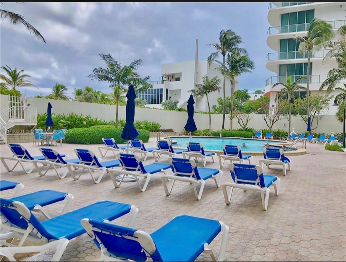 Swimming pool with lounge chairs - 4001 S Ocean Dr