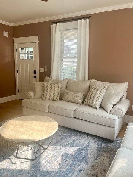 Inside the front door an open living room with plush furnishings await! - 20 Summer St