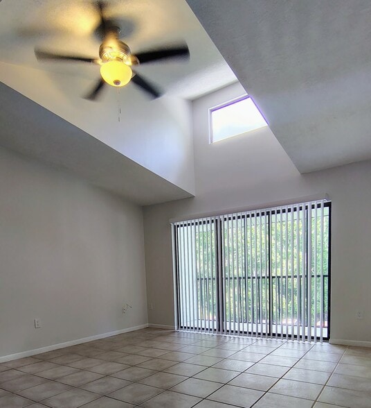 View from breakfast bar onto balcony and preserve in morning sun; new verticals! - 1353 Pine Ridge Cir E