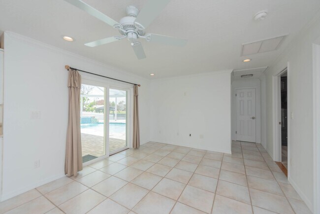 Building Photo - Live the ultimate Space Coast waterfront lifestyle at this stunning beachside canal home in Satel...