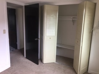 Bed room closet door looking into bathroom - Gilcrest Apartments - Utilities Included