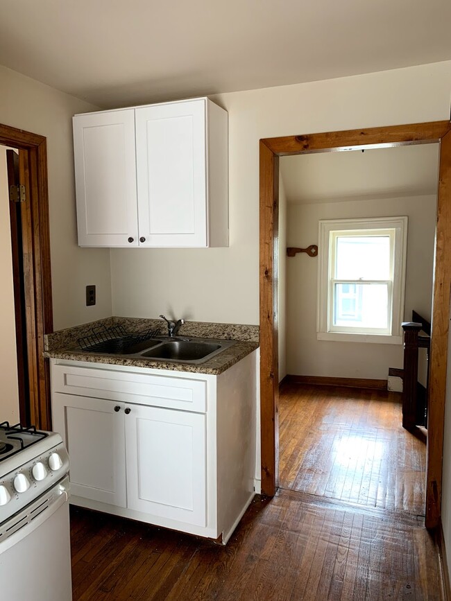 Kitchen - Left door leads to bedroom, right doorway leads to entryway, bathroom and living room - 39 Congress St