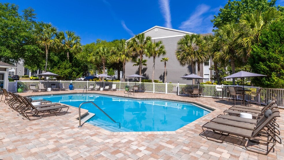 Our resort-style pool features shaded seating, modern loungers, and a beautifully landscaped sundeck that’s perfect for relaxing or entertaining. - The Enclave at Huntington Woods