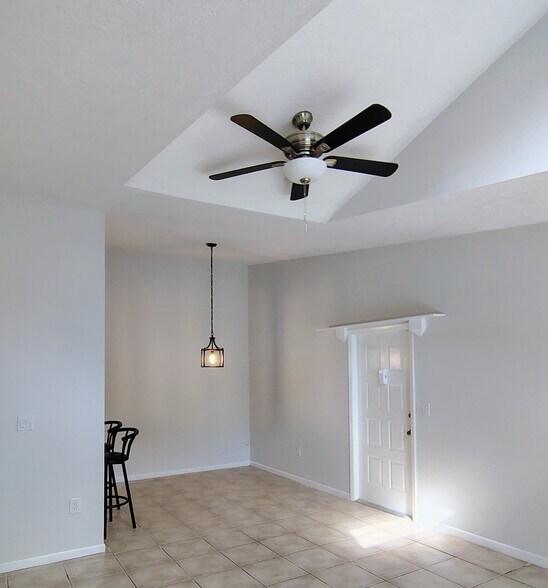 Dining room by entry door, new ceiling fan over LR - 1353 Pine Ridge Cir E