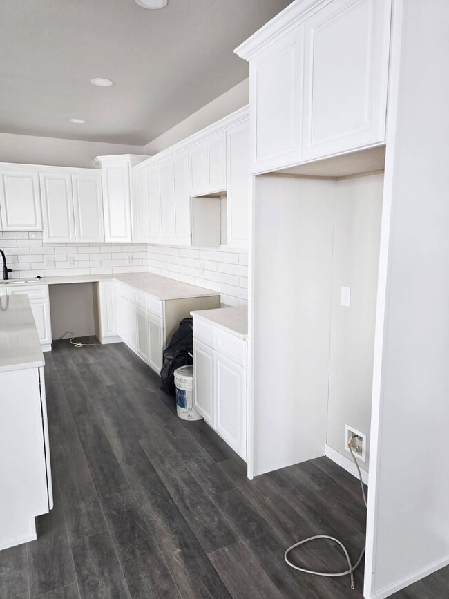 Step into sophistication at Paradise Valley Townhomes. This stunning kitchen features sleek white cabinetry, modern fixtures, and plenty of space for culinary creativity. Embrace a lifestyle of comfort and style. Schedule your tour today! - Paradise Valley Townhomes & Apartments