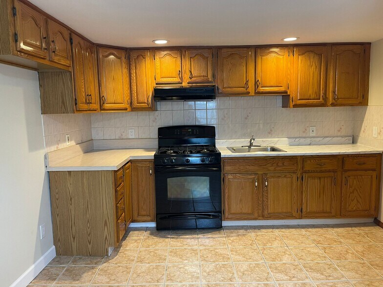Kitchen with Stove, Oven and Cabinets - 9 Manchester Ave