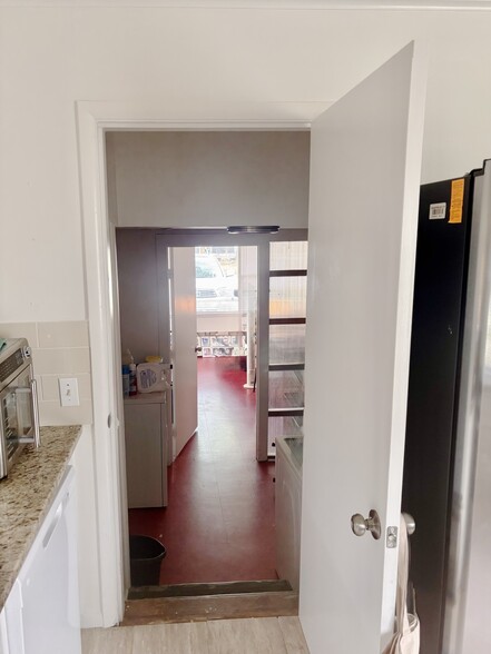 Looking from the kitchen down to the laundry room and the office or play room. - 3516 E 30th St