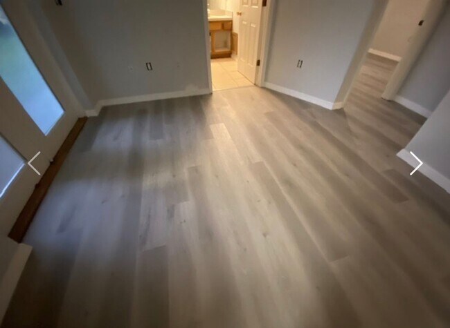 Building Photo - Available NOW! NEW FLOORS AND PAINT! Lovely 3/2 in Poinciana! HUGE fenced yard and NO CARPET!