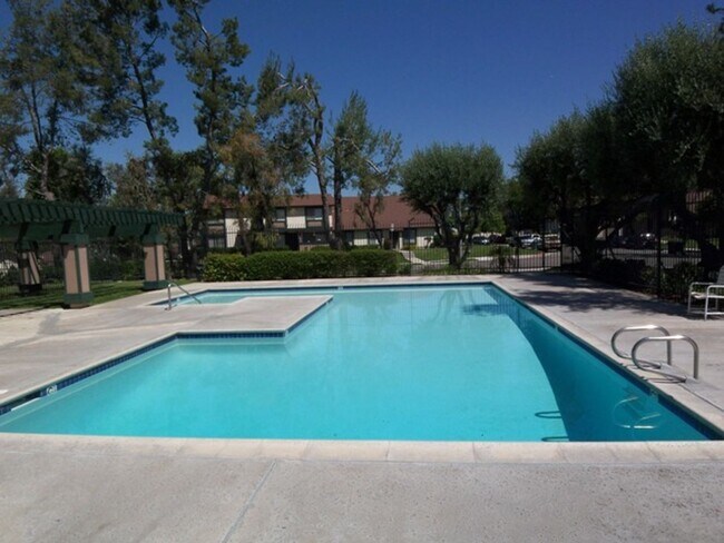 Building Photo - REMODELED 2BR; 1BA end unit condo w/ 1 car garage & 1 parking space