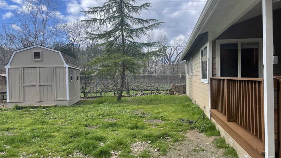 View of back deck, tenant's shed, and neighbor's vineyard. - 3289 CA-128