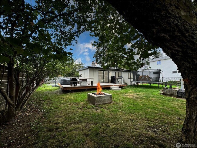 Building Photo - Remodeled 3 bdrm home on a large lot with 500 sq ft wrap around deck!