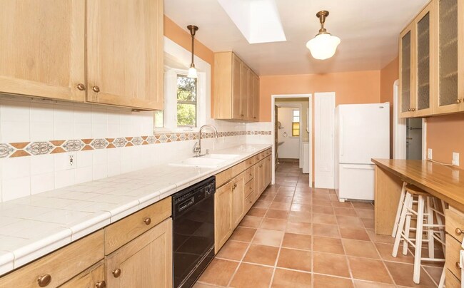 Building Photo - Charming Spanish Style Cottage with Incredible Deck- Gardener's Delight!