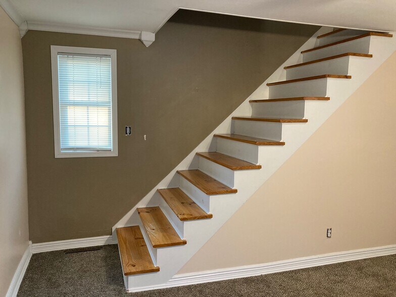 Stairs from Living room to Upstairs -- Handrail needs reinstalled - 910 E High St