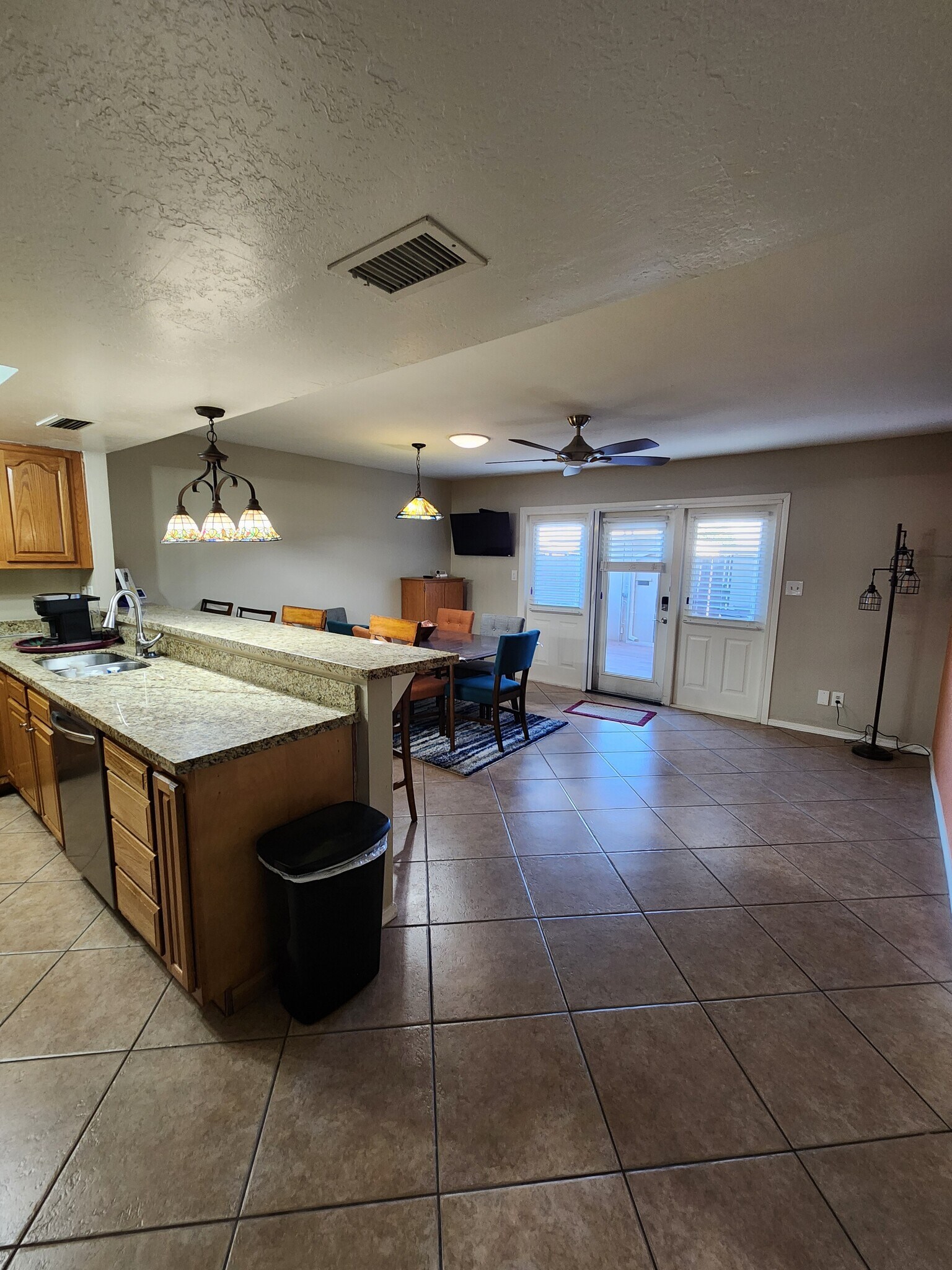 Breakfast bar, dining room leads to covered patio. - 5050 N 81st St