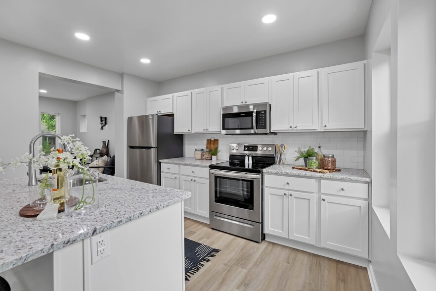 Gourmet, luxury granite countertops kitchen with stainless steel appliances - 185 N Harris Ave