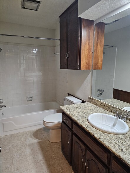 Main hall nathroom with tub-shower surround. - 2104 NW 118th Ter